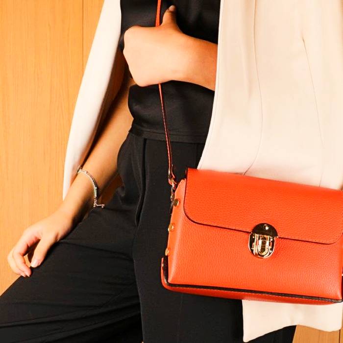 Best selling orange leather crossbody bag with gold buckle and adjustable shoulder strap