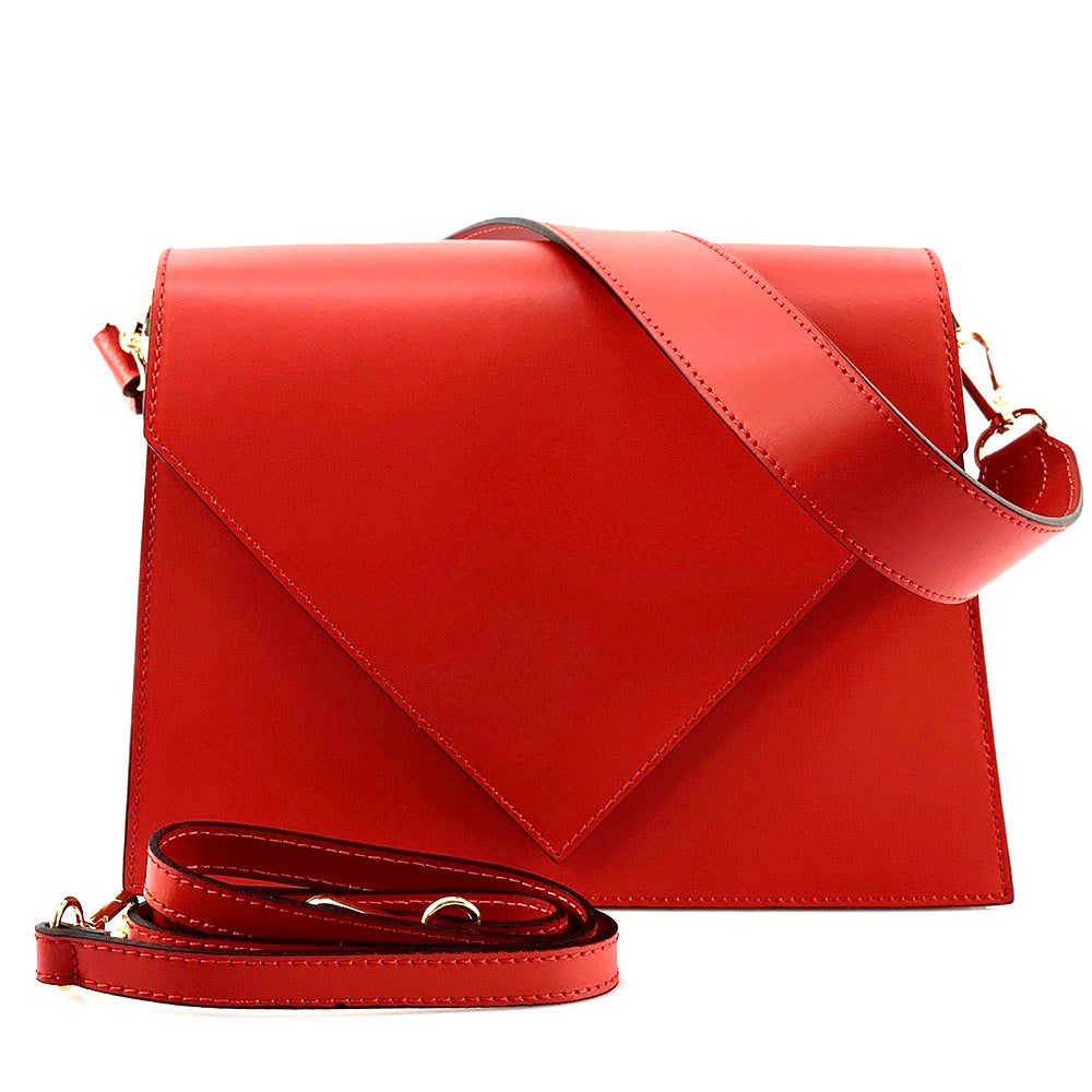 Red leather handbag with a strap on a white background