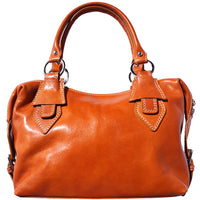 The handbag closed, highlighting its classic design, handles, and shoulder strap.