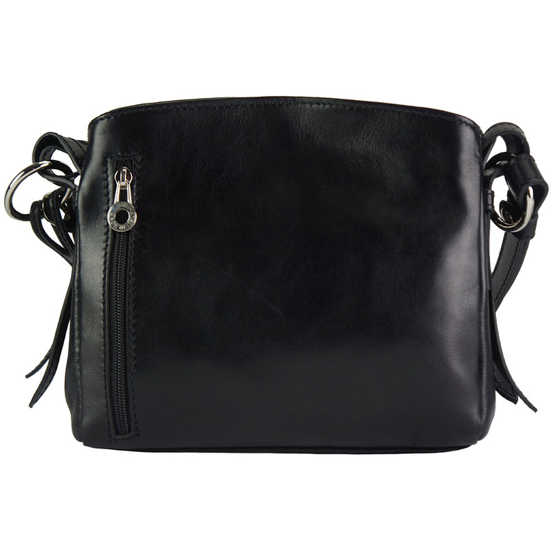 The handbag closed, highlighting its classic design and adjustable shoulder strap.