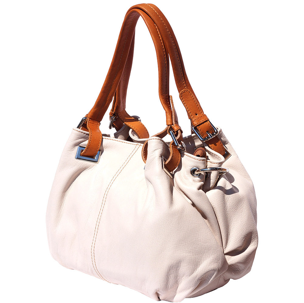 Angled view of Valentina leather handbag in creme with brown strap