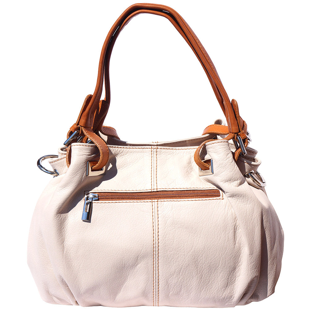 The Valentina Leather Sling Bag displayed in handbag mode, showcasing the double handles and interior.