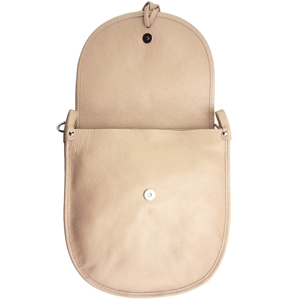 Interior view of the Elisa cross-body bag in pink showing button closure